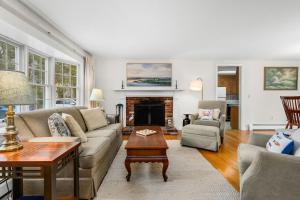 a living room with a couch and a fireplace at Cozy Cape Escape Near Beaches Dining in Centerville