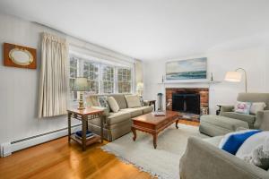 a living room with a couch and a fireplace at Cozy Cape Escape Near Beaches Dining in Centerville +20 photos