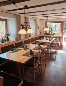 a restaurant with tables and chairs in a room at Bürgerstüble in Sankt Peter