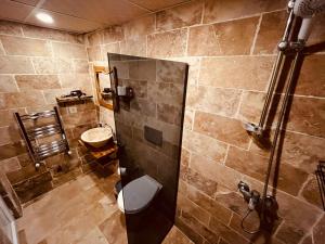a bathroom with a shower and a toilet and a sink at Cherrykonak cappadocia in Uçhisar +68 photos