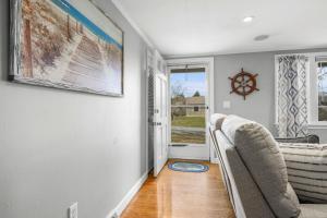 a living room with two chairs and a window at Dog-Friendly Cape Cod Getaway with Fire Pit Yard in South Yarmouth