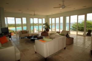 a living room with white furniture and a view of the ocean at Spectacular views in Long Path