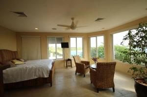 a bedroom with a bed and a table and windows at Spectacular views in Long Path +22 photos