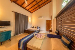 a room with a bed and a couch in it at Owinmo Hotel & reception Hall in Galle