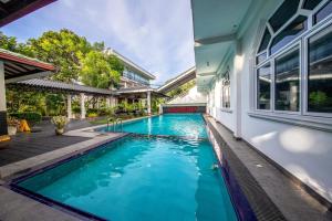 a swimming pool in the backyard of a house at Owinmo Hotel & reception Hall in Galle