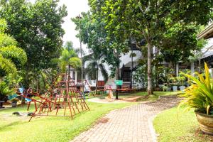 a playground in a park with a red metal structure at Owinmo Hotel & reception Hall in Galle