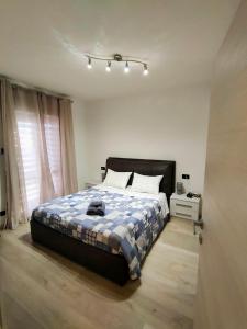 a bedroom with a bed with a blue and white blanket at Dimora di Teglio in Teglio