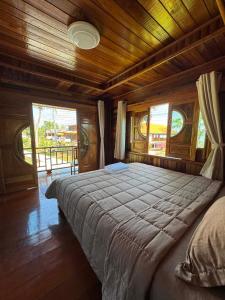 a bedroom with a large bed with a wooden ceiling at Lamphu Resort Koh Lanta at Lanta Old Town in Ko Lanta