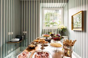 a table with many different types of food on it at Nus Hotel Poerio in Rome