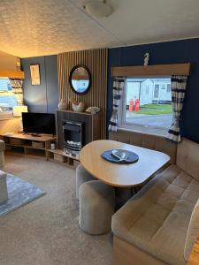 a living room with a table and a couch at Withernsea sands-Maple grove in Waxholme