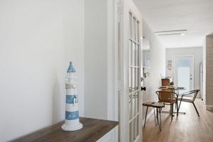 a living room with a lighthouse vase on a table at Naples Triplex Retreat in Naples +11 photos