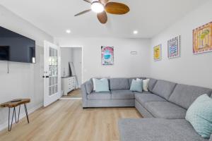 a living room with a couch and a ceiling fan at Naples Triplex Retreat in Naples