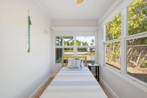 a white room with windows and a bench at Naples Triplex Retreat in Naples