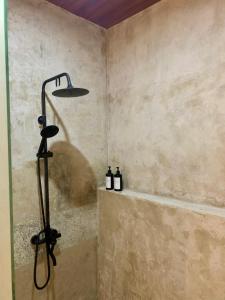 a shower in a bathroom with a shower head at Verdana Jungle Retreat Ubud in Ubud +22 photos