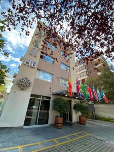 a hotel with flags in front of a building at Hotel Boutique Reyall in Santiago