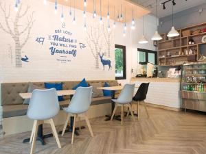 a restaurant with a table and chairs in a room at Shade House - Bitec Bangna in Bangkok