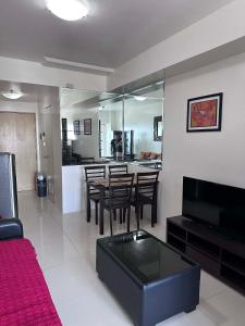 a living room with a table and chairs and a kitchen at SMDC Tagaytay Condominium in Kaybagal +7 photos