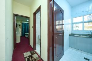 a bathroom with a shower and a sink and a mirror at Quality Hotel Apartments in Sabkhah +22 photos