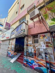 a store front of a building in a street at Quality Hotel Apartments in Sabkhah