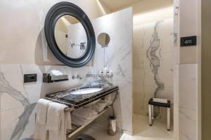a bathroom with a sink and a mirror at Art Hotel Commercianti in Bologna +279 photos