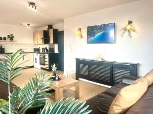 a living room with a couch and a table at Spacious 3BR City Centre Apartment Free Parking in Liverpool