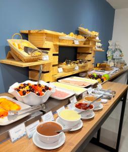 a buffet with many different types of food on a table at Jardins Almare Apart Hotel in João Pessoa +190 photos