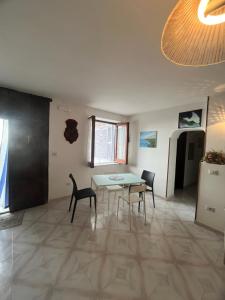a dining room with a table and two chairs at Intera casa con giardino, vista mare e montagna in Maratea