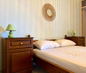 a bedroom with two beds and a mirror on the wall at Natasa studios Kythera in Kythira