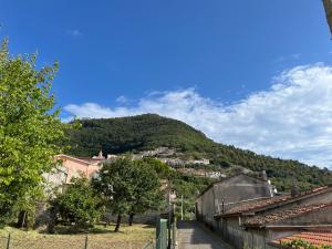 a view of a mountain with a town on a hill at Intera casa con giardino, vista mare e montagna in Maratea