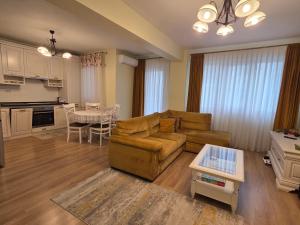 a living room with a couch and a table at Apartament Rose in Gura Humorului