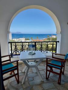 a table and two chairs on a balcony with a view at Natasa studios Kythera in Kythira