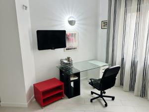 a room with a desk and a red chair at AragonApartment in Santa Maria a Vico