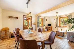 a dining room with a wooden table and chairs at Ferienwohnung am Bertenberg -Keßler in Diemelsee