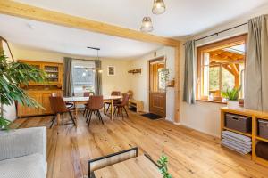 an open living room with a table and chairs at Ferienwohnung am Bertenberg -Keßler in Diemelsee