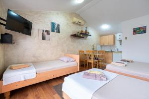 a room with two beds and a kitchen with a table at M Group Studios in Tivat +20 photos