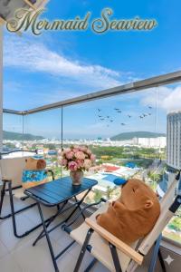 a balcony with a table and chairs and a view at Mermaid-Oasky-50m to ThápTamThắng&Biển in Vung Tau