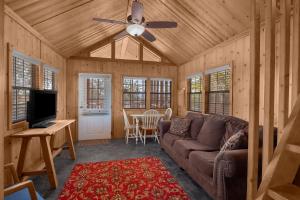 a living room with a couch and a ceiling fan at Sun Outdoors Canyonlands Gateway in Moab