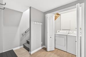 a white laundry room with a washer and dryer at Hameau 33-104 in Stoneham +15 photos