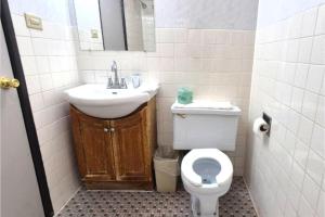 a bathroom with a sink and a toilet and a mirror at Motel Edgebrook Chicago North Shore By Oyo in Chicago +39 photos