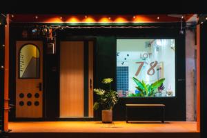 a sign in the window of a store with a plant at Lot 78 in Malacca