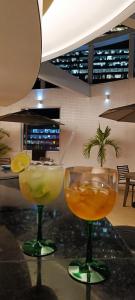 two cocktails sitting on a counter in a restaurant at Hotel Atlântico Tower in Rio de Janeiro