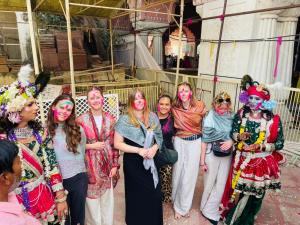a group of women posing for a picture with painted faces at Joey's Hostel Jaipur in Jaipur