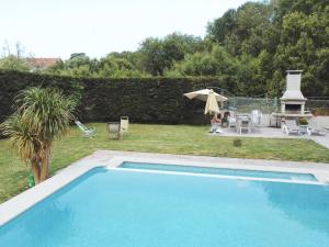 a large swimming pool in a yard with a yard at Apartamentos Avenida Areas II in Sanxenxo