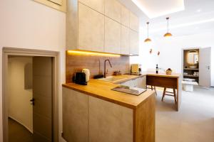 a kitchen with a sink and a counter top at Caldera Jewel Santorini in Firostefani