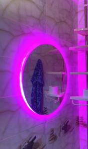 a mirror with pink lights in a room at Yamna home in Agadir +30 photos