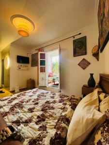 a bedroom with a large bed and a window at Yamna home in Agadir