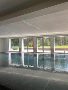 a large empty room with a large pool of water at Maison Poluc - Le Petit Chalet in Champoluc