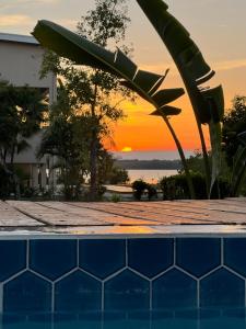 a pool with a sunset in the background at Tortuga Amarilla 1 in Maya Beach +6 photos
