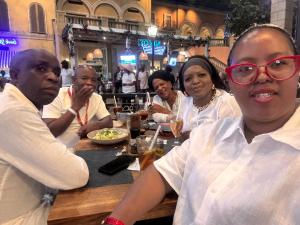 a group of people sitting at a table in a restaurant at Folang Resort in Centurion