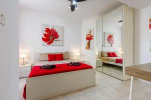 a bedroom with a large bed and a mirror at Bright 3BR Penthouse with Pool & BBQ in Msida by QuickTrips in Misraħ Il-Barrieri +36 photos